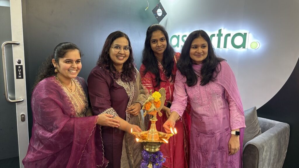 Colleagues lighting the traditional brass lamp at the Vela Technologies India office inauguration